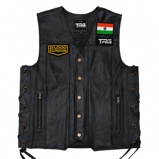 20 Thousand Kilometres embroidered patch attached to chest of black leather motorcycle vest on white background