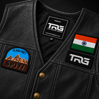 Close-up of 15K Feet Spiti embroidery patch on black TRG leather vest with Indian flag patch and TRG logo patch.