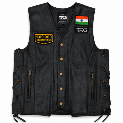 1 Lakh Kilometres embroidered patch attached to black leather motorcycle vest on white background