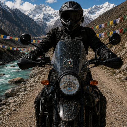Born to Ride Sticker installed on motorcycle windshield during Himalayan adventure ride with rider, mountains and prayer flags
