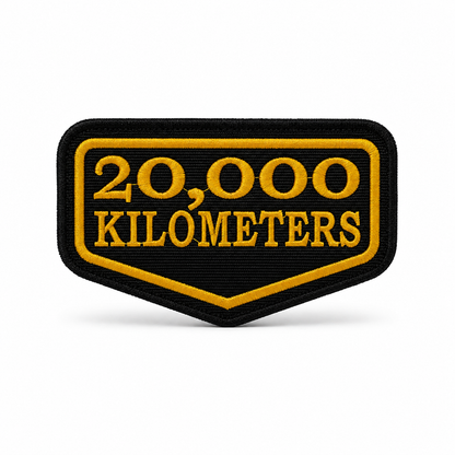 20 Thousand Kilometres embroidered patch in black and yellow with precision stitched border on white background