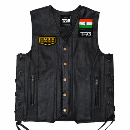 20 Thousand Kilometres embroidered patch attached to chest of black leather motorcycle vest on white background