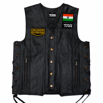 30 Thousand Kilometres embroidered patch attached to black leather motorcycle vest showing front chest placement on white background