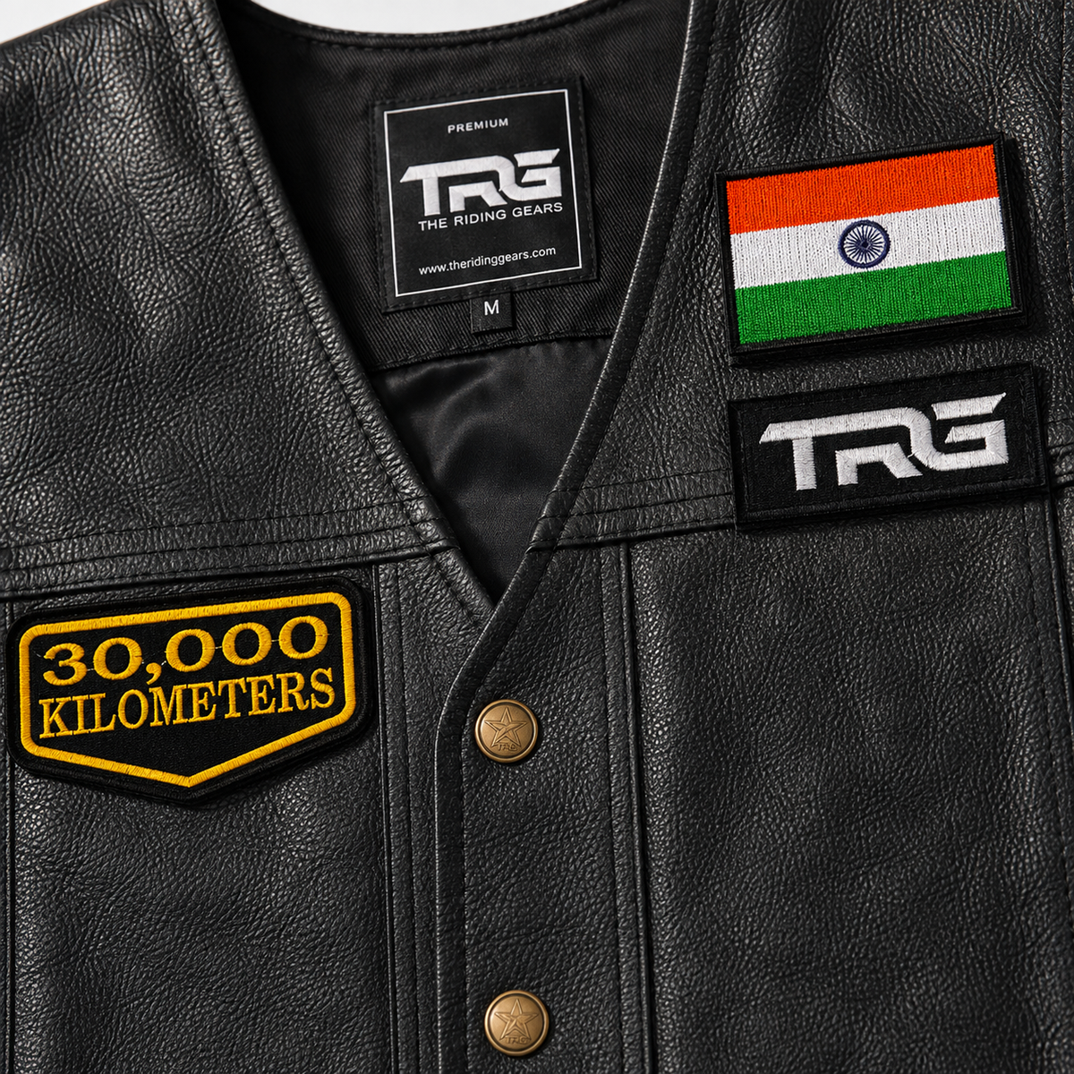 Close-up of 30 Thousand Kilometres embroidered patch on black leather vest showing yellow embroidery, black twill base and stitched border