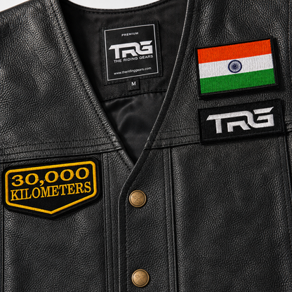 Close-up of 30 Thousand Kilometres embroidered patch on black leather vest showing yellow embroidery, black twill base and stitched border