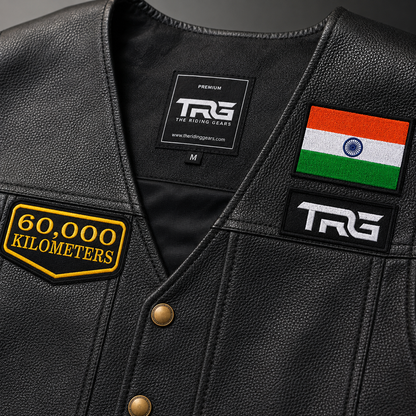 Close-up of 60,000 Kilometres embroidered patch on black leather motorcycle vest showing detailed embroidery and stitching