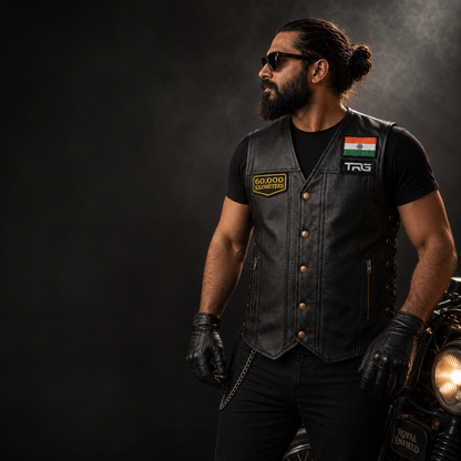 Biker wearing 60,000 Kilometres embroidered patch on black leather motorcycle vest in premium dark studio setting