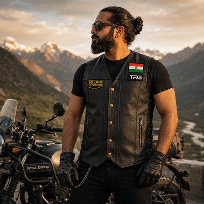 Motorcycle rider wearing 80 Thousand Kilometres embroidered patch on black leather vest during mountain ride