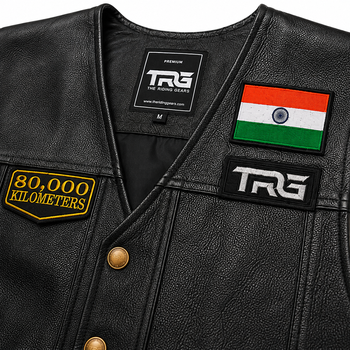 80 Thousand Kilometres embroidered patch close-up on black leather riding vest showing detailed yellow embroidery