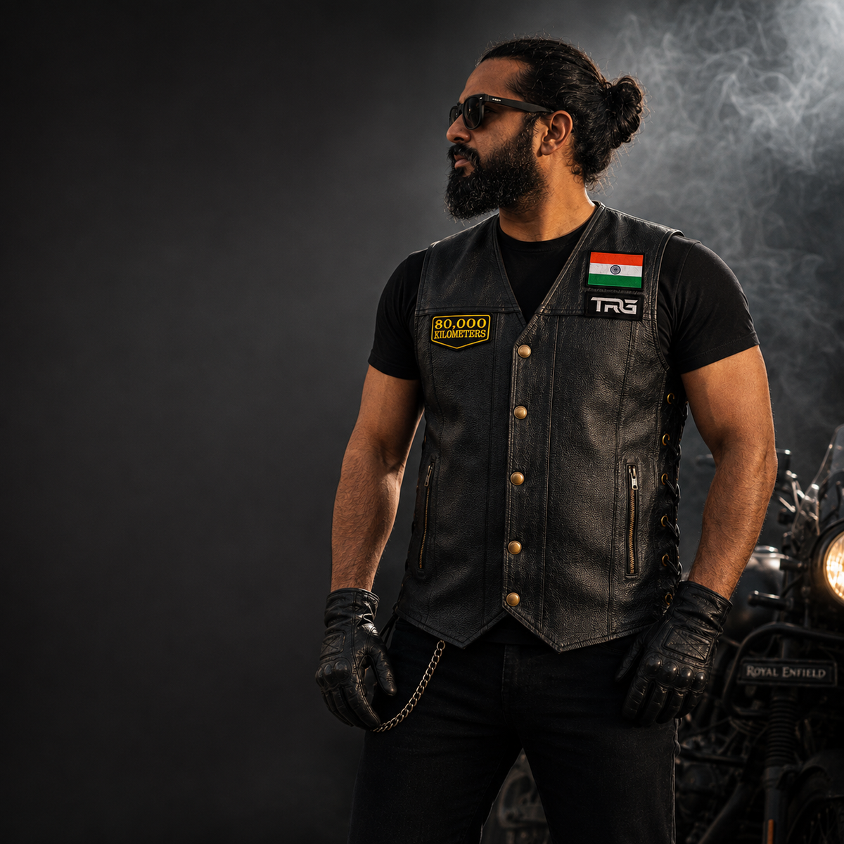 Motorcycle rider wearing 80 Thousand Kilometres embroidered patch on black leather vest beside motorcycle