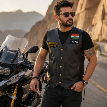 Motorcycle rider wearing 3 Lakh Kilometres embroidered patch on leather vest during adventure ride