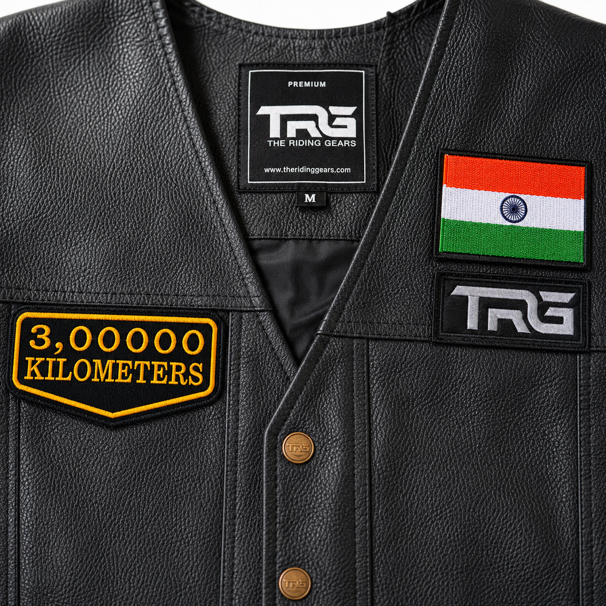 Close-up of 3 Lakh Kilometres embroidered patch showing detailed yellow embroidery and black twill fabric