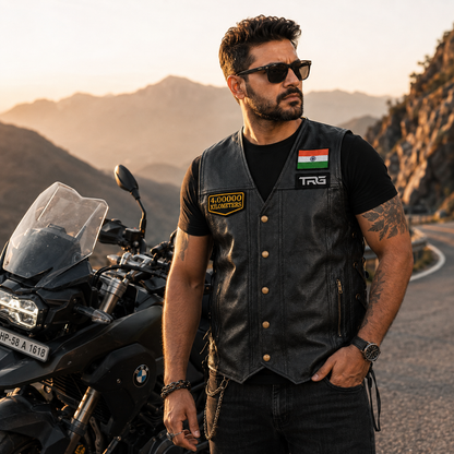 Motorcycle rider wearing 4 Lakh Kilometres embroidered patch on black leather vest during mountain ride