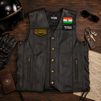 4 Lakh Kilometres embroidered patch displayed on black leather riding vest with motorcycle riding accessories