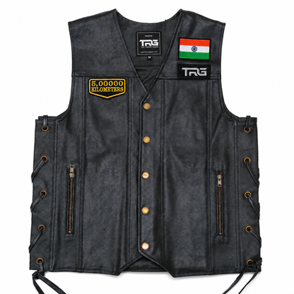 5 Lakh Kilometres embroidered patch attached to black leather motorcycle vest showing front chest placement on white background
