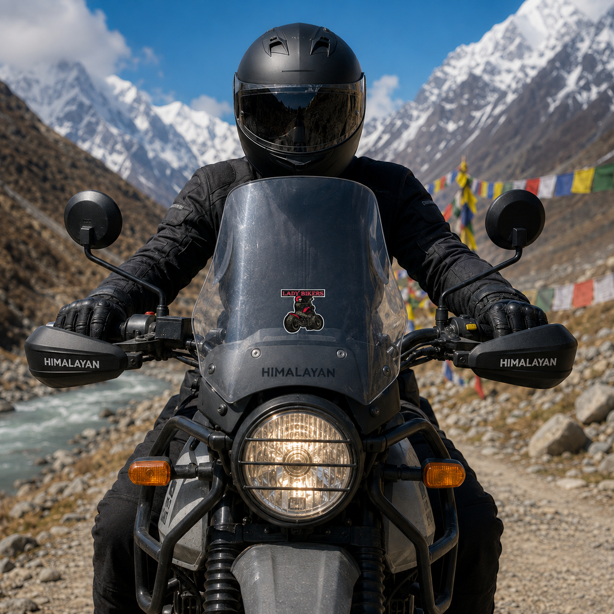 Lady Biker sticker centered on Royal Enfield Himalayan motorcycle windshield on a scenic Himalayan mountain road