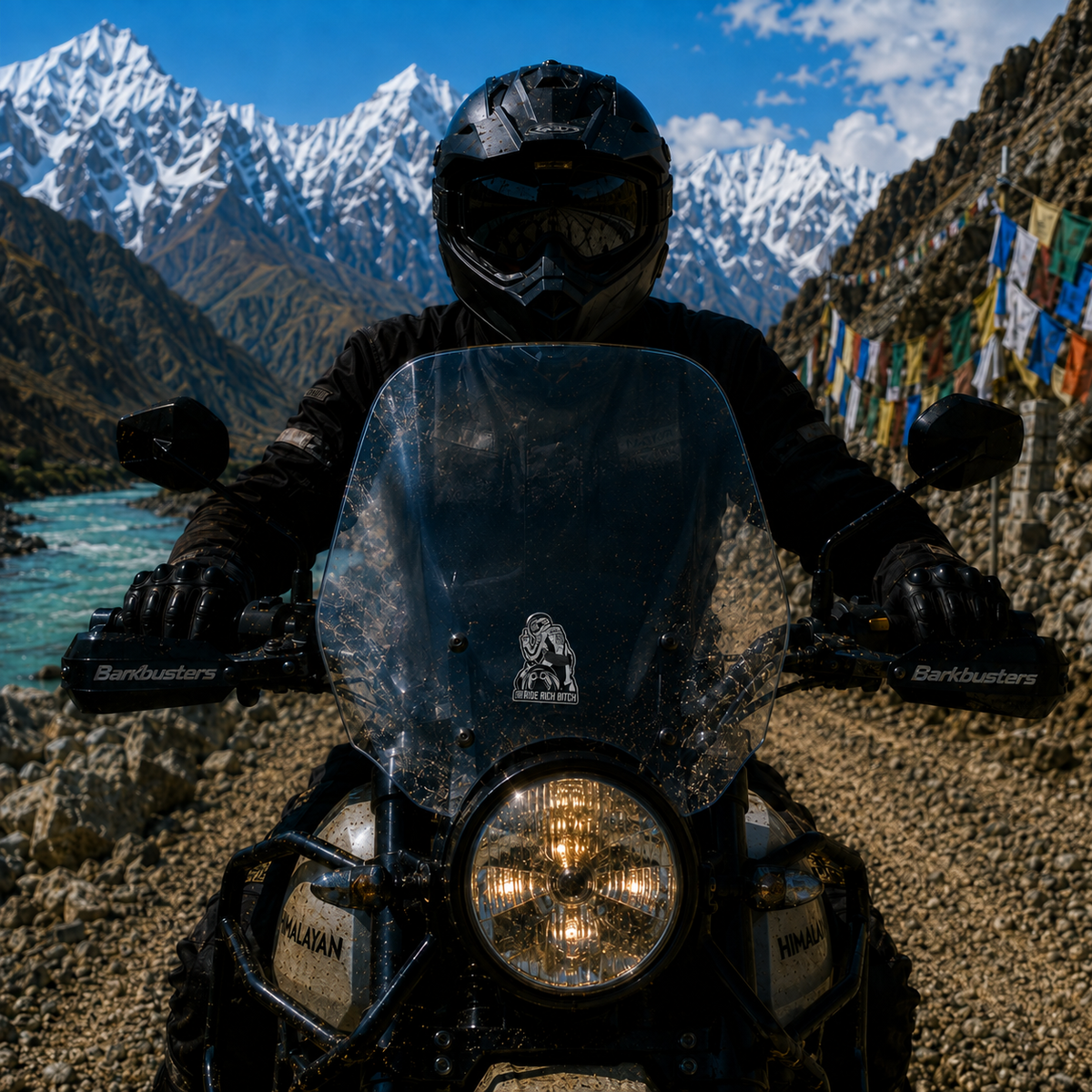 RIDE RICH BITCH Motorcycle Sticker displayed on an adventure motorcycle windshield in a Himalayan mountain setting