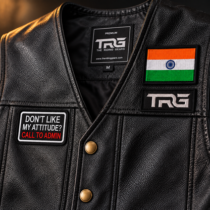 Attitude biker patch close-up showing detailed white red and black embroidery on leather riding vest