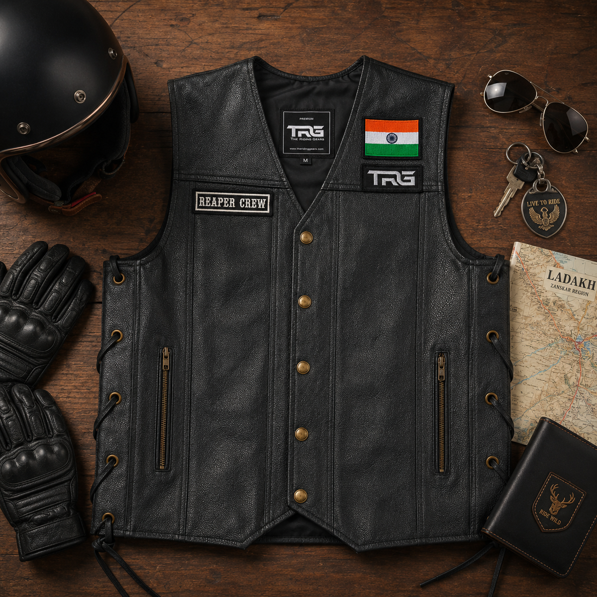 Biker patch Reaper Crew displayed on black leather motorcycle vest in premium rider flat lay