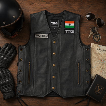Biker patch Reaper Crew displayed on black leather motorcycle vest in premium rider flat lay
