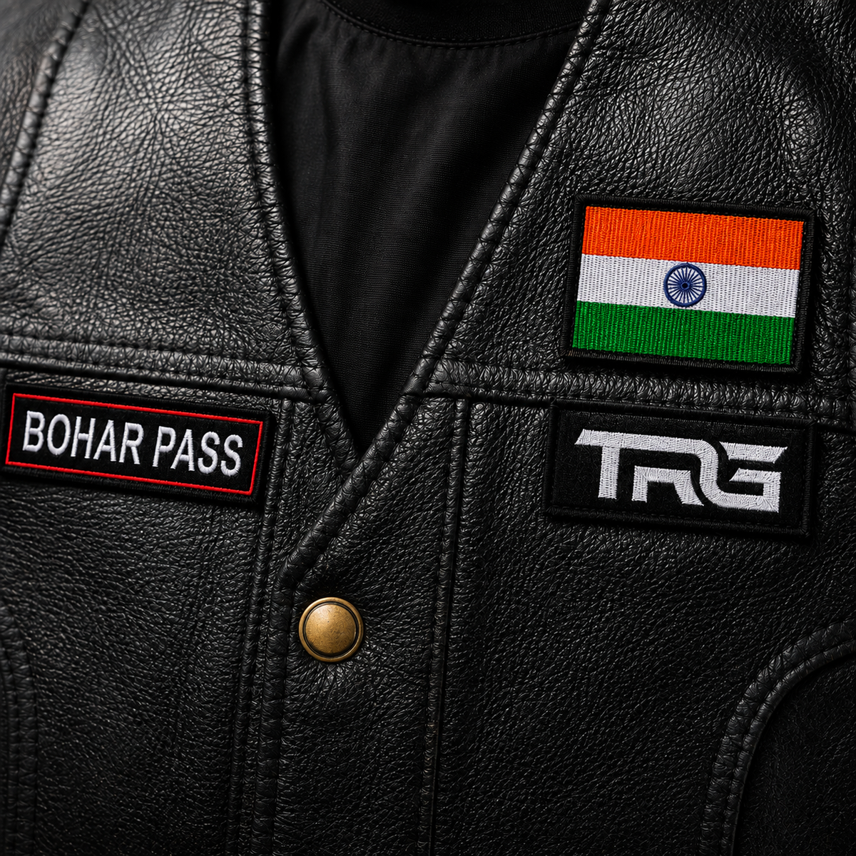 Close-up of Bohar Pass embroidery patch on black TRG leather vest with Indian flag and TRG chest patch.
