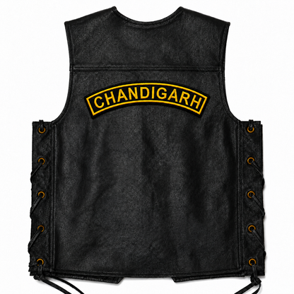 Black leather vest back view featuring the Chandigarh Top Curved embroidery patch placed across the upper back on a white background.