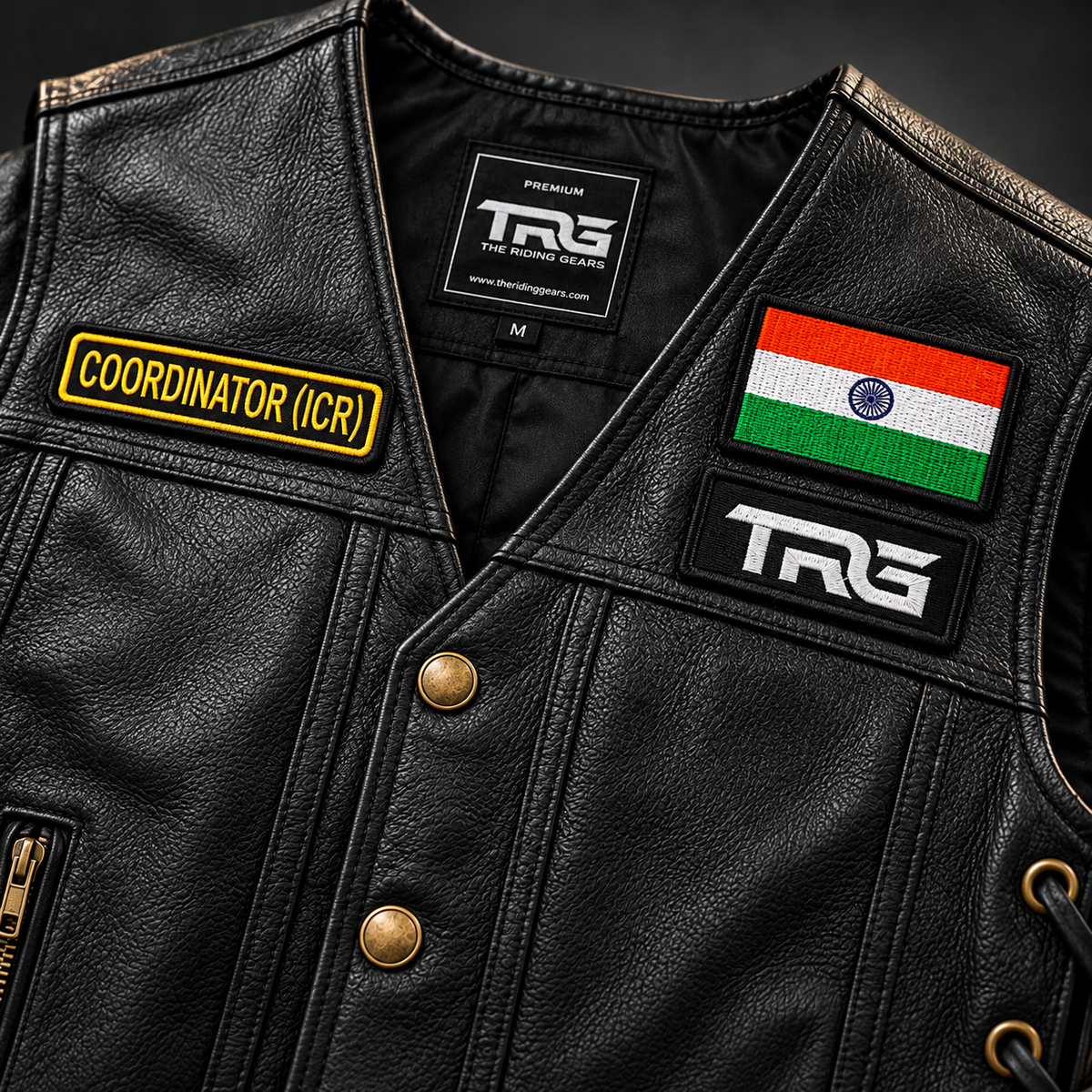 Coordinator (ICR) front designation embroidered patch close-up on a black leather motorcycle riding vest with TRG and Indian Flag patches.