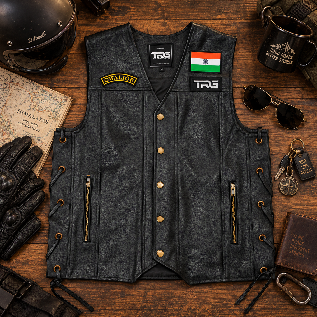 Gwalior embroidered front patch displayed on a black leather biker vest with motorcycle riding accessories.