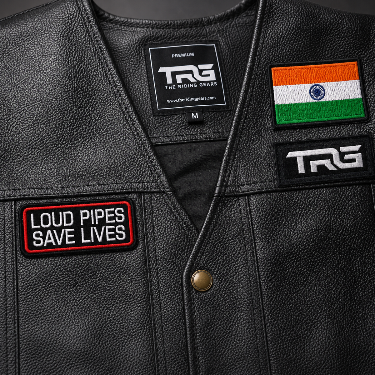 Loud Pipes Save Lives Biker Patch close-up showing white embroidery with red border on black leather vest