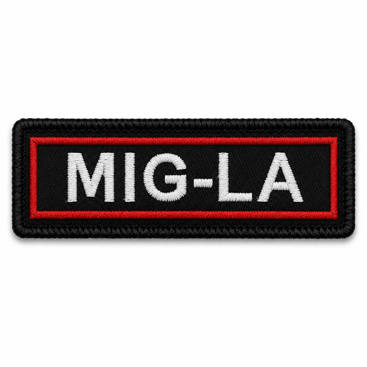 MIG-LA embroidered patch with white lettering, red inner border, and black background on white backdrop.