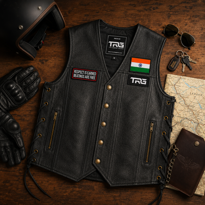 Respect Is Earned Beatings Are Free embroidered patch displayed on black leather riding vest with biker accessories.