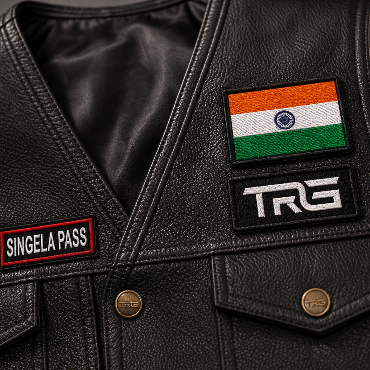 Close-up of Singela Pass expedition embroidery patch by TRG on a black leather riding vest